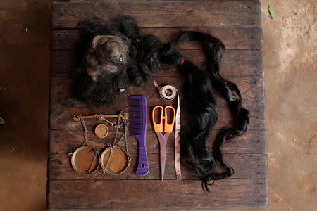 The contents of Thidar Win's bag after a day of hair collecting are seen in a village in Yangon, Myanmar August 22, 2018. REUTERS/Ann Wang