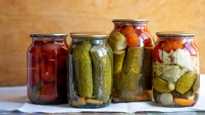 four jars of pickled vegetables