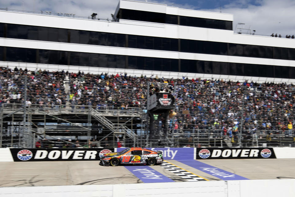 Martin Truex Jr. (19) crosses the finish line to win the NASCAR 400 auto race at Dover Motor Speedway, Monday, May 1, 2023, in Dover, Del. (AP Photo/Jason Minto)