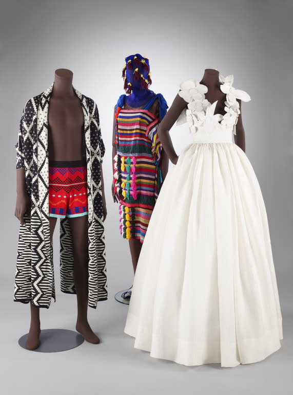 A display of contemporary African labels’ pieces. From L to R: Maxhosa Africa, IAMISIGO, Imane Ayissi. - Credit: © Victoria and Albert Museum