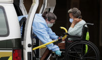 A resident is removed from the Southeast Nursing and Rehabilitation Center in San Antonio, Friday, April 3, 2020. Officials say several residents and staff have tested positive for COVID-19 at the facility. (AP Photo/Eric Gay)