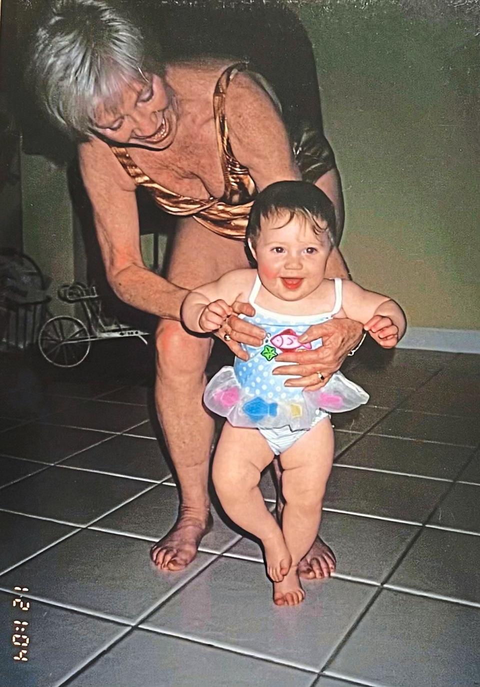 Grandma holding Natalie while she walks