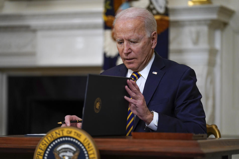 President Joe Biden closes the folder after signing an executive order relating to U.S. supply chains, in the State Dining Room of the White House, Wednesday, Feb. 24, 2021, in Washington. (AP Photo/Evan Vucci)