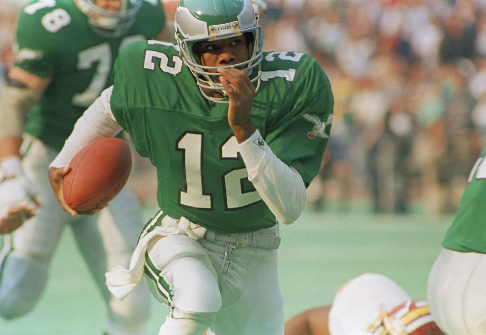 Philadelphia Eagles quarterback Randall Cunningham runs with the ball for a 45-yard gain against the Washington Redskins during first quarter action in Philadelphia, Nov. 9, 1987. Cunningham ran for 80-yards and passed for 268 yards to lead the Eagles to a 31-27 victory. (AP Photo/Amy Sancetta)