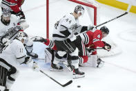 Chicago Blackhawks' Ryan Donato (8) is unable to get a clean shot on goal and falls to the ice as Los Angeles Kings' Mikey Anderson (44) defends during the second period of an NHL hockey game Friday, March 15, 2024, in Chicago. (AP Photo/Charles Rex Arbogast)