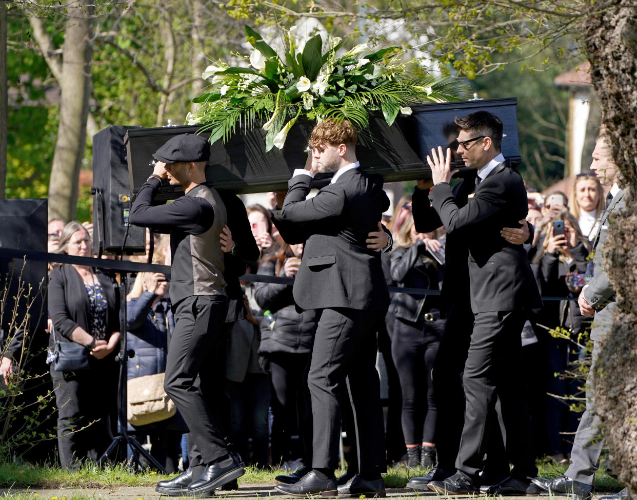 Max George and Jay McGuiness of The Wanted carry the coffin at the funeral of their bandmate Tom Parker