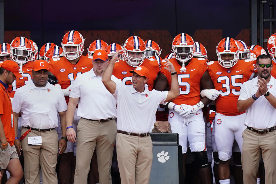 Clemson head coach Dabo Swinney, center, prepares to lead his team onto the field for an NCAA college football game against Georgia Tech, Saturday, Sept. 18, 2021, in Clemson, S.C. (AP Photo/John Bazemore)