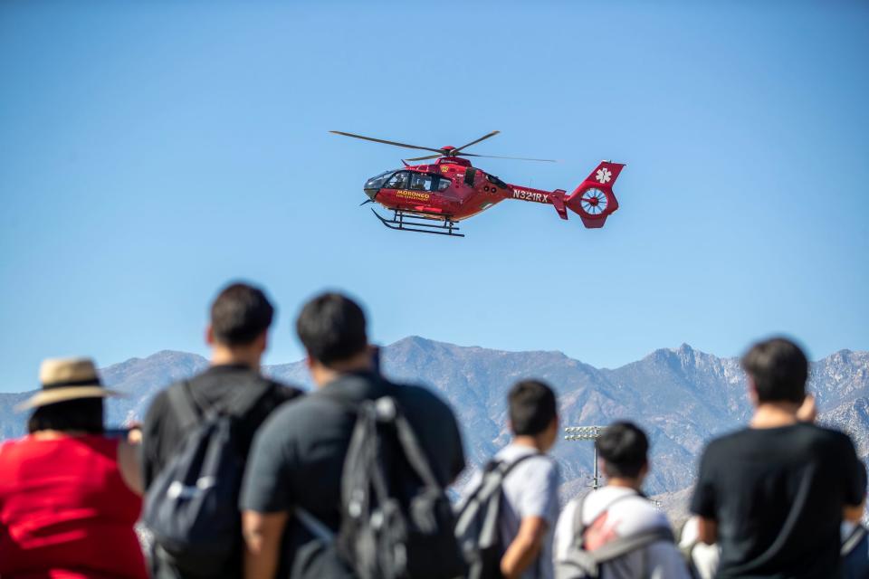 Cathedral City High School students watch a medical helicopter land on the school grounds during the Great Shakeout Drill in Cathedral City, Calif., on Thursday, October 18, 2023.