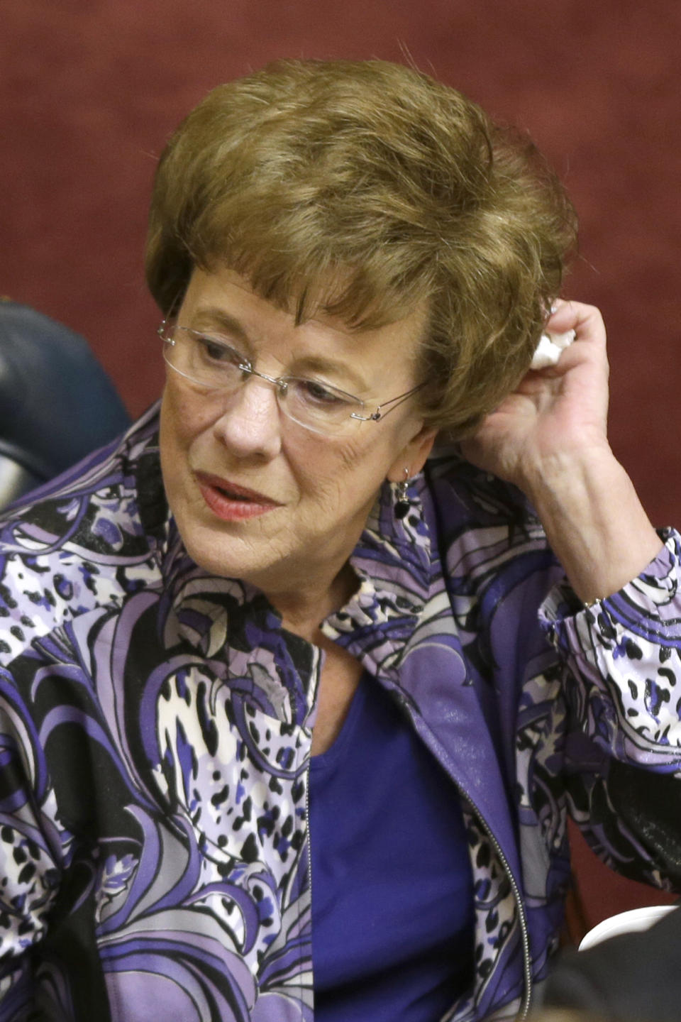 Sen. Jane English, R-North Little Rock, sits at her desk in the Senate chamber at the Arkansas state Capitol in Little Rock, Ark., Thursday, Feb. 20, 2014. The Senate voted to reauthorize funding for the "private option" program that uses federal Medicaid funds to purchase private insurance for low-income residents. (AP Photo/Danny Johnston)