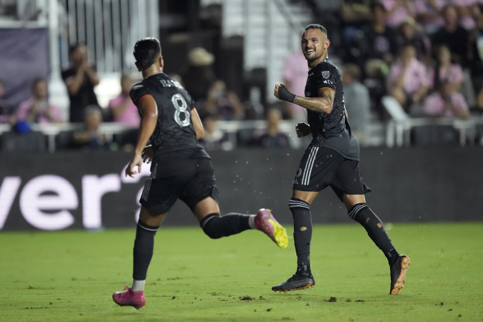 Houston Dynamo midfielder Artur, right, celebrates after Houston Dynamo midfielder Amine Bassi (8) scored on a penalty in the first half of the U.S. Open Cup final soccer match against Inter Miami, Wednesday, Sept. 27, 2023, in Fort Lauderdale, Fla. (AP Photo/Rebecca Blackwell)