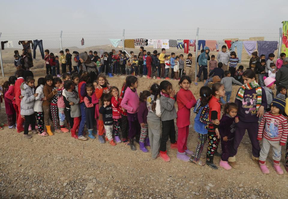Iraqi internally displaced children gather for gifts before a New Year's celebration at the Hassan Sham camp, east of Mosul, Iraq, Saturday, Dec 31, 2016. (AP Photo/ Khalid Mohammed)