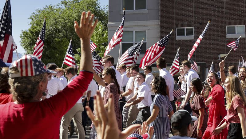 Paradegoers wave to the members of The Church of Jesus Christ of Latter-day Saints’ Utah Provo Mission during the America’s Freedom Festival Grand Parade in Provo on Monday, July 4, 2022.
