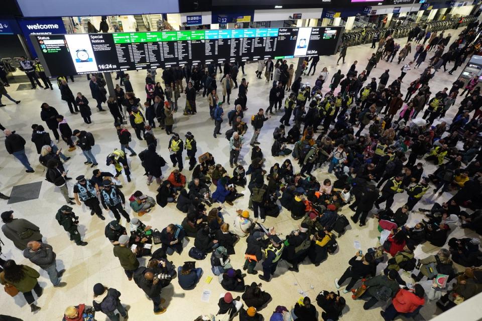 Police officers remove pro-Palestinian protesters that took part in a sit-in demonstration at London's Waterloo Station (Stefan Rousseau/PA Wire)