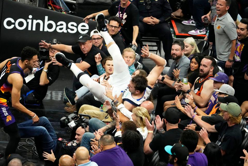 May 10, 2022; Phoenix, Arizona, USA; Dallas Mavericks guard Luka Doncic (77) dives into the crowd during action against the Phoenix Suns during game five of the second round for the 2022 NBA playoffs at Footprint Center.