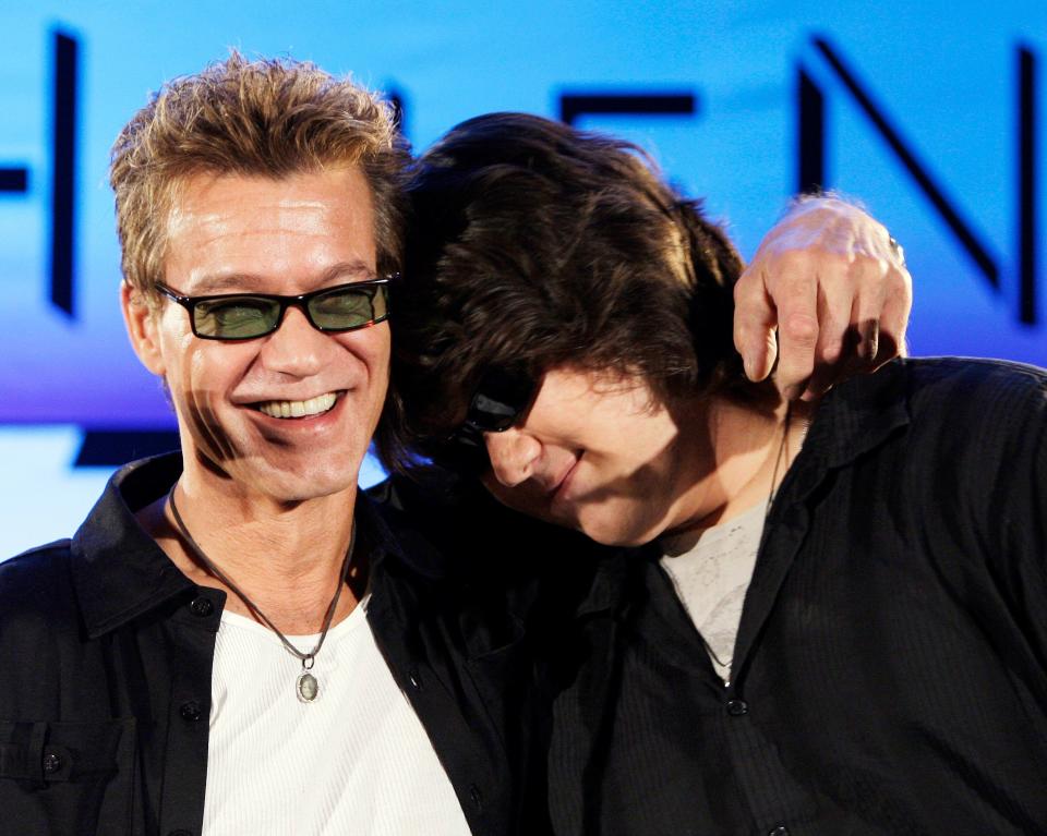 Eddie Van Halen, left, embraces his son Wolfgang Van Halen after the rock group Van Halen officially announced their North American tour during a news conference in Los Angeles on Aug. 13, 2007.