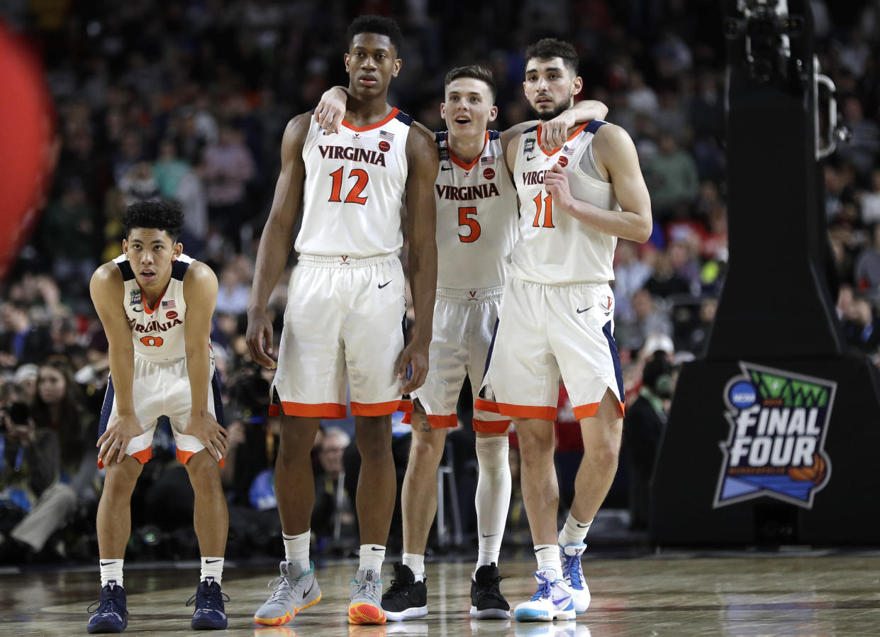 Virginia players Kihei Clark, from left, De'Andre Hunter, Kyle Guy and Ty Jerome celebrate at the end of the championship game against Texas Tech in the Final Four NCAA college basketball tournament, Monday, April 8, 2019, in Minneapolis. Virginia won 85-77 in overtime. (AP Photo/David J. Phillip)