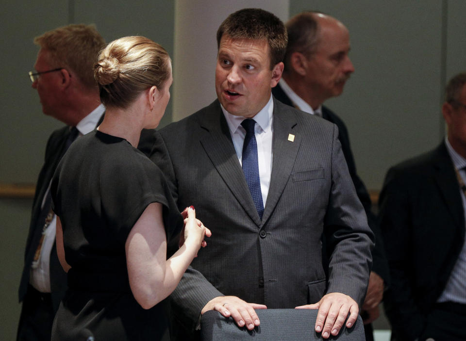 Estonian Prime Minister Juri Ratas, center, speaks with Danish Prime Minister Mette Frederiksen during a round table meeting at an EU summit in Brussels, Sunday, June 30, 2019. European Union leaders have started another marathon session of talks desperately seeking a breakthrough in a diplomatic fight over who should be picked for a half dozen of jobs at the top of EU institutions. (Geoffroy Van Der Hasselt, Pool Photo via AP)
