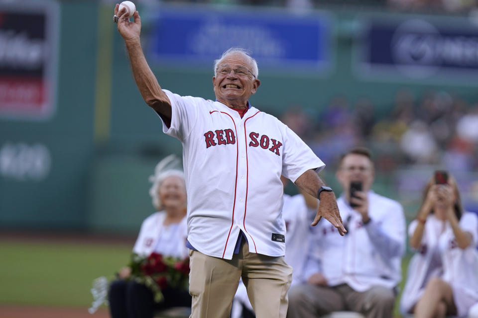Boston Red Sox broadcaster Joe Castiglione throws a ceremonial first pitch before a baseball game between the Cleveland Guardians and the Red Sox, Thursday, July 28, 2022, in Boston. The Red Sox honored Castiglione before the game for his 40 years on the air with the team. (AP Photo/Steven Senne)
