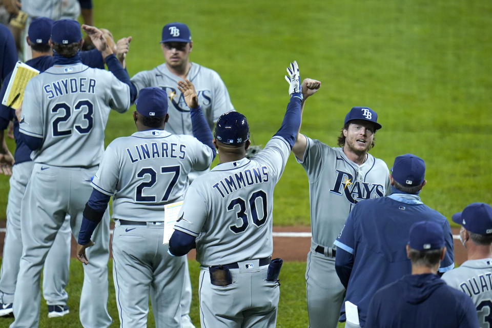 Tampa Bay Rays players celebrate after defeating the Baltimore Orioles in the second game of a baseball doubleheader, Thursday, Sept. 17, 2020, in Baltimore. The Rays won 10-6 to clinch a playoff berth. (AP Photo/Julio Cortez)