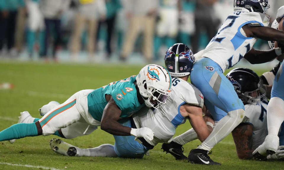 Miami Dolphins cornerback Kader Kohou (4) sacks Tennessee Titans quarterback Will Levis (8) during the second half of an NFL football game, Monday, Dec. 11, 2023, in Miami. (AP Photo/Lynne Sladky)