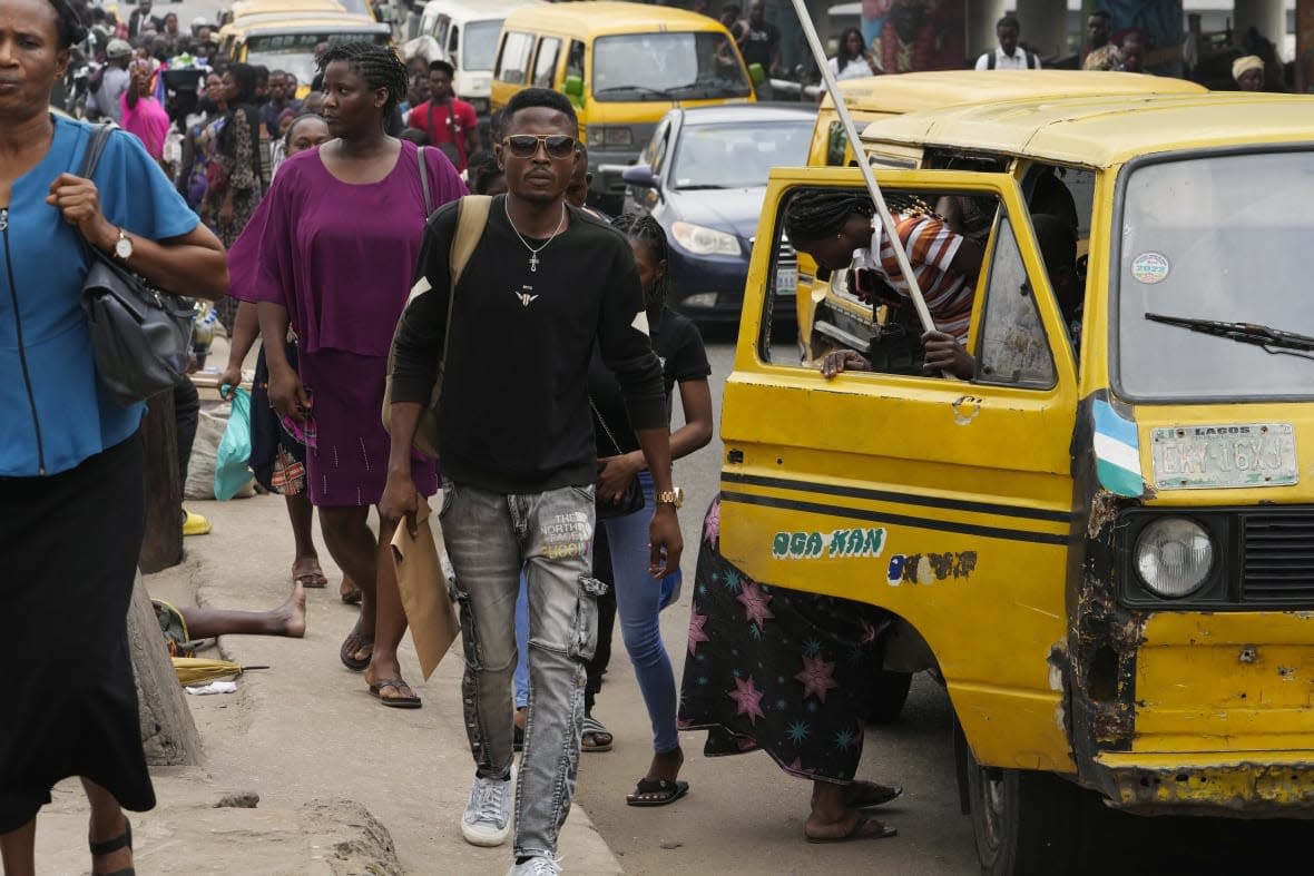 People walk during rush hour on Nov. 14, 2022 in Lagos, Nigeria. The world’s population is projected to hit an estimated 8 billion people on Tuesday, Nov. 15, according to a United Nations projection. (AP Photo/Sunday Alamba)