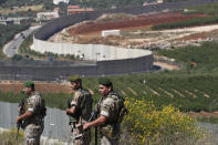 FILE - In this May 15, 2021 file photo, Lebanese army soldiers deploy at the Lebanese side of the Lebanese-Israeli border in the southern village of Kfar Kila, Lebanon. The currency collapse has wiped out the salaries of the U.S.-backed Lebanese military, placed unprecedented pressure on the army's operational capabilities with some of the highest attrition rates over the past two years, and raised concerns about its ability to continue playing a stabilizing role while sectarian tensions and crime are on the rise. (AP Photo/Hussein Malla, File)