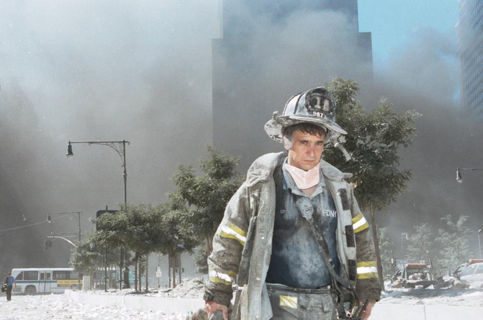 An unidentified New York City firefighter walks away after the collapse of the Twin Towers (Getty)