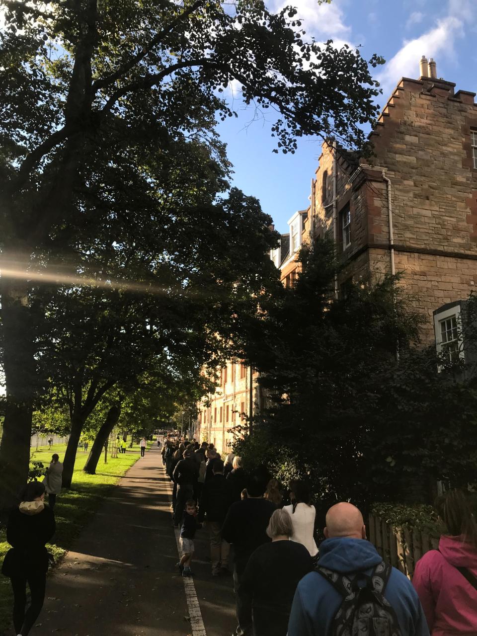 Vast crowds line the perimeter of the Edinburgh Meadows as people queue to pay their respects to the late Queen (Holly Bancroft/The Independent)