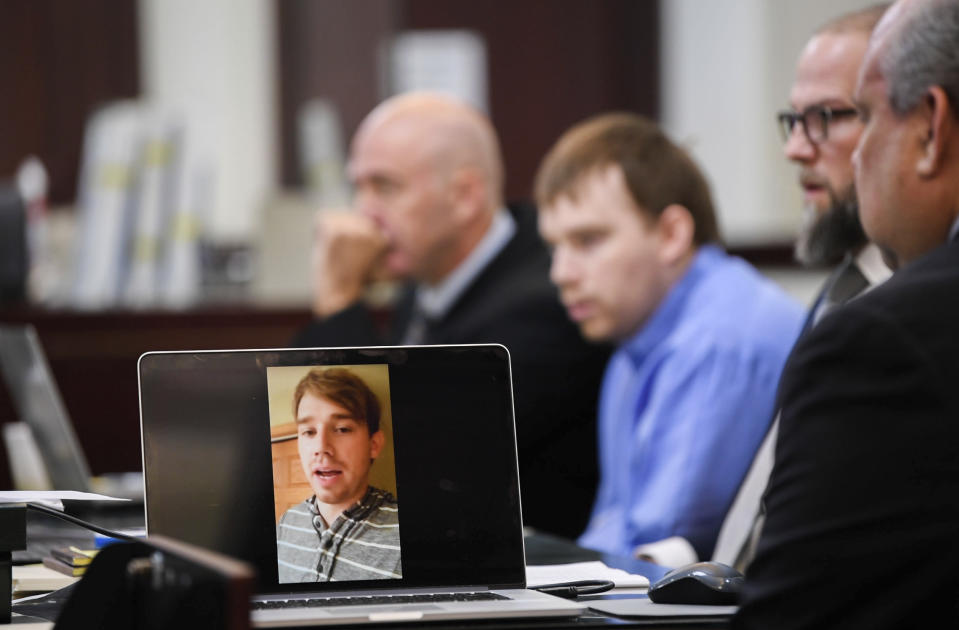 Travis Reinking watches a video of himself describing the day he was having, believing someone broke into his home, lifted the toilet seat up and touched his laptop, in court on day four of the mass murder trial at Justice A.A. Birch Building in Nashville, Tenn., Thursday, Feb. 3, 2022. (Stephanie Amador/The Tennessean via AP, Pool)