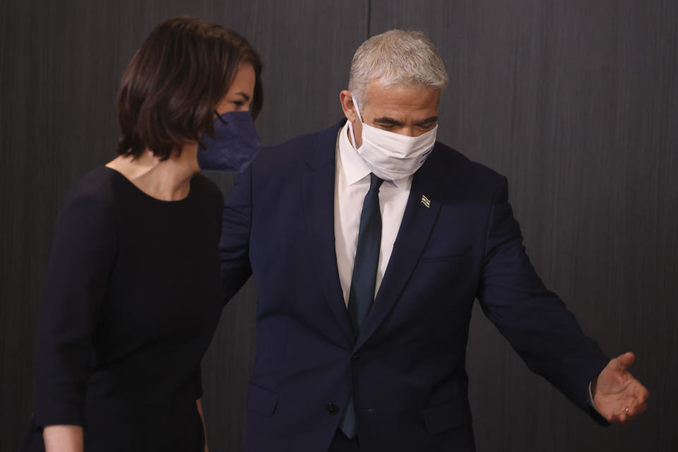 German Foreign Minister Annalena Baerbock and Israeli Foreign Minister Yair Lapid arrive for a joint press conference in Tel Aviv, Israel, Thursday, Feb. 10, 2022. (AP Photo/Oren Ziv)