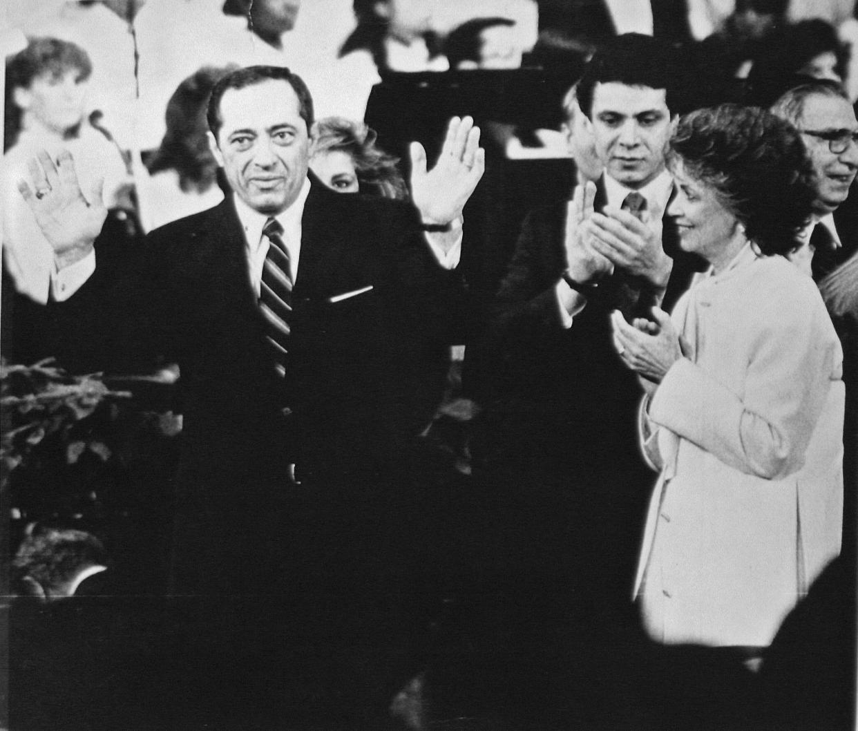 Gov. Mario Cuomo, left, acknowledges applause at the inauguration as wife Matilda and son Andrew look on Jan. 1, 1987.