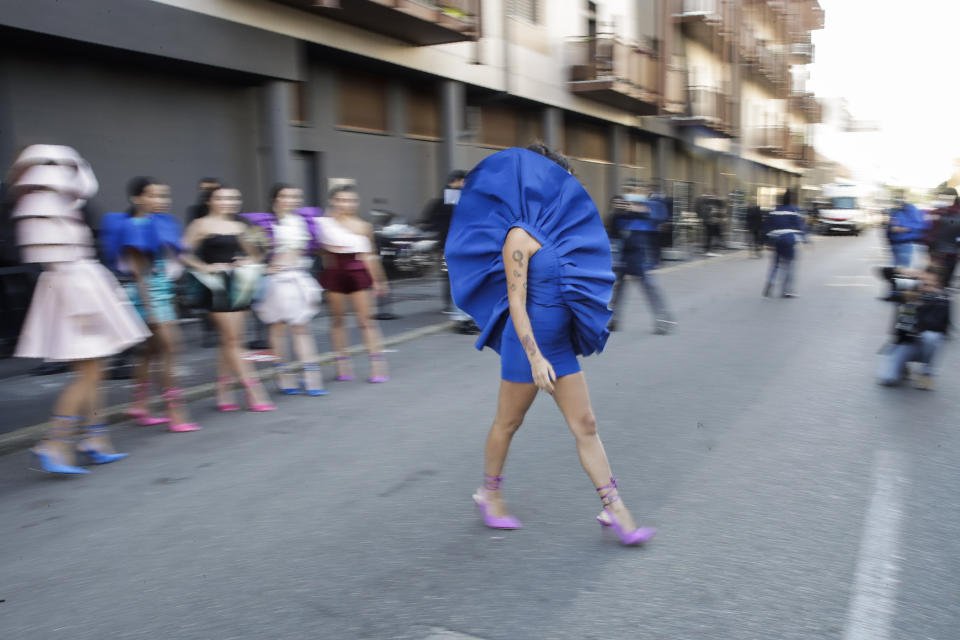 Fashion student Nora Bourelly shows her creation outside Valentino women's Spring-Summer 2021 fashion show location, in Milan, Italy, Sunday, Sept. 27, 2020. (AP Photo/Luca Bruno).