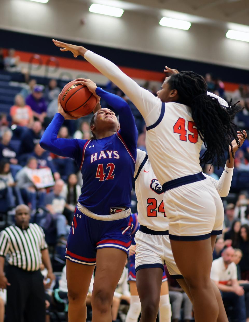 Hays' Madi Disu fights through a foul on her way to scoring during the Hawks' 65-32 win over Glenn on Tuesday night. "This was a statement win for our team," Hays coach Danny Preuss said. Hays improved to 10-0 in District 25-5A.