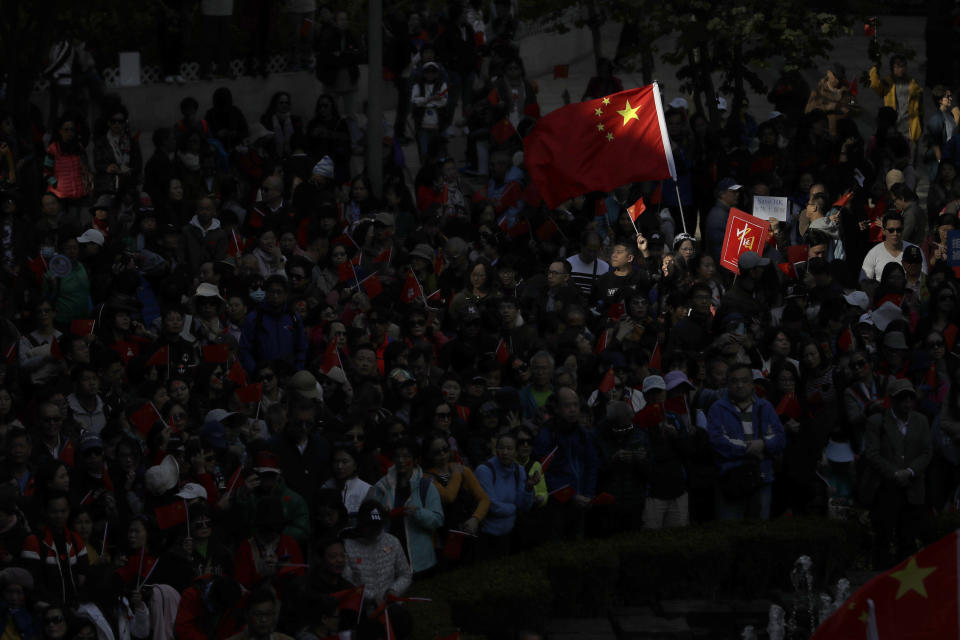 Pro-Beijing supporters wave the Chinese national flags during a rally in Hong Kong on Saturday, Dec. 7, 2019. Six months of unrest have tipped Hong Kong's already weak economy into recession. (AP Photo/Mark Schiefelbein)