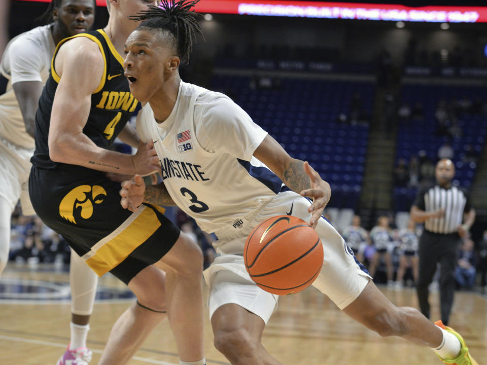 Penn State's Nick Kern Jr. (3) drives the baseline against Iowa's Josh Dix (4) during the first half of an NCAA college basketball game Thursday, Feb. 8, 2024, in State College, Pa. (AP Photo/Gary M. Baranec)