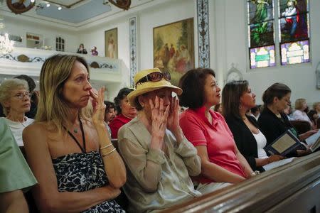 People cry while they attend the last mass at the Church of Our Lady Peace in New York July 31, 2015. REUTERS/Eduardo Munoz