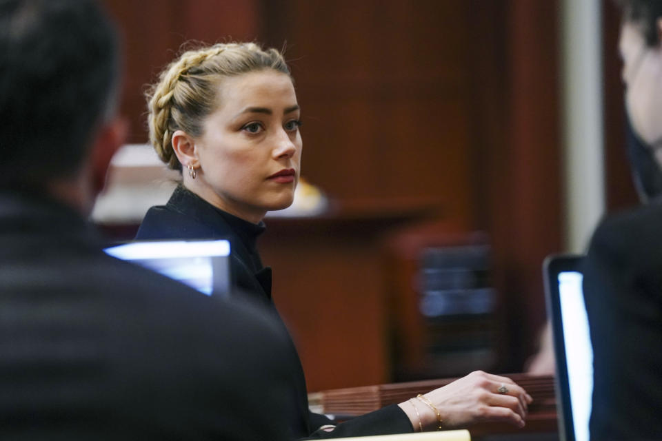 Actress Amber Heard sits in the courtroom at the Fairfax County Circuit Courthouse in Fairfax, Va., Thursday, April 14, 2022. Actor Johnny Depp sued his ex-wife Amber Heard for libel in Fairfax County Circuit Court after she wrote an op-ed piece in The Washington Post in 2018 referring to herself as a “public figure representing domestic abuse.” (Shawn Thew/Pool Photo via AP)