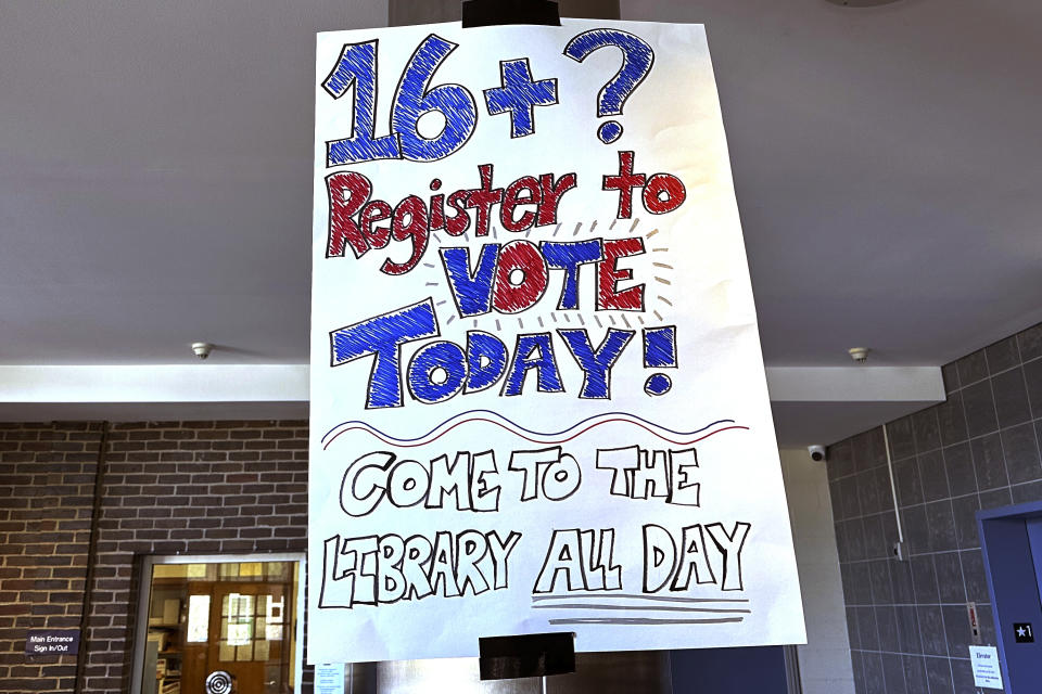 A sign is posted at Brattleboro Union High School suggesting students register to vote during a voter drive at the school, Feb. 14, 2024, in Brattleboro, Vt. 16 and 17-year-olds in Brattleboro will get to vote in local elections and if they're 18 by the November general election they can cast ballots in the Super Tuesday presidential primary. (AP Photo/Lisa Rathke)