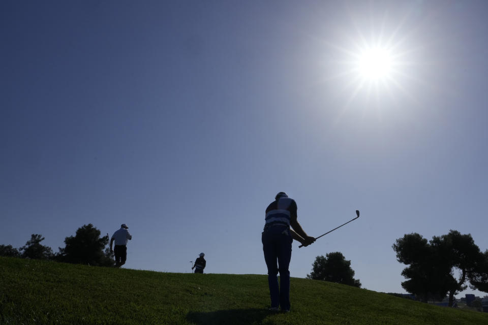 United States' Max Homa chips onto the 1st green during a practice round ahead of the Ryder Cup at the Marco Simone Golf Club in Guidonia Montecelio, Italy, Wednesday, Sept. 27, 2023. The Ryder Cup starts Sept. 29, at the Marco Simone Golf Club. (AP Photo/Andrew Medichini)