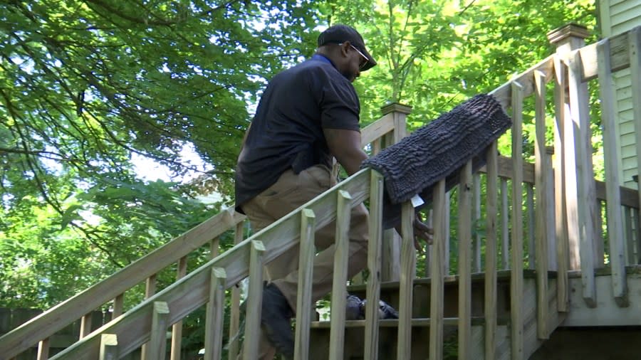 Jason Harris, HQS Inspector for the Lansing Housing Commission, inspects a railing Wednesday morning. (WLNS)