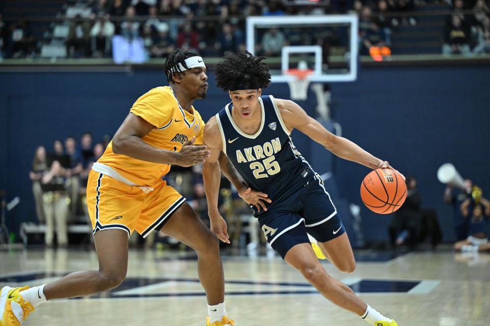 Akron forward Enrique Freeman dribbles past Toledo forward Javan Simmons on Friday in Akron.