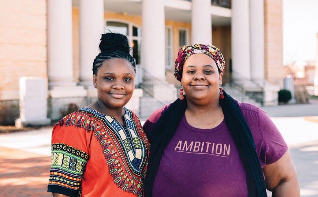 Black History Collective of Henderson County founder Crystal Cauley, right, stands with her daughter, Tiara Channer, at the Historic Henderson County Courthouse.