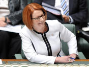 <p>Julia Gillard laughs during Question Time, despite Labor's predicament.</p>