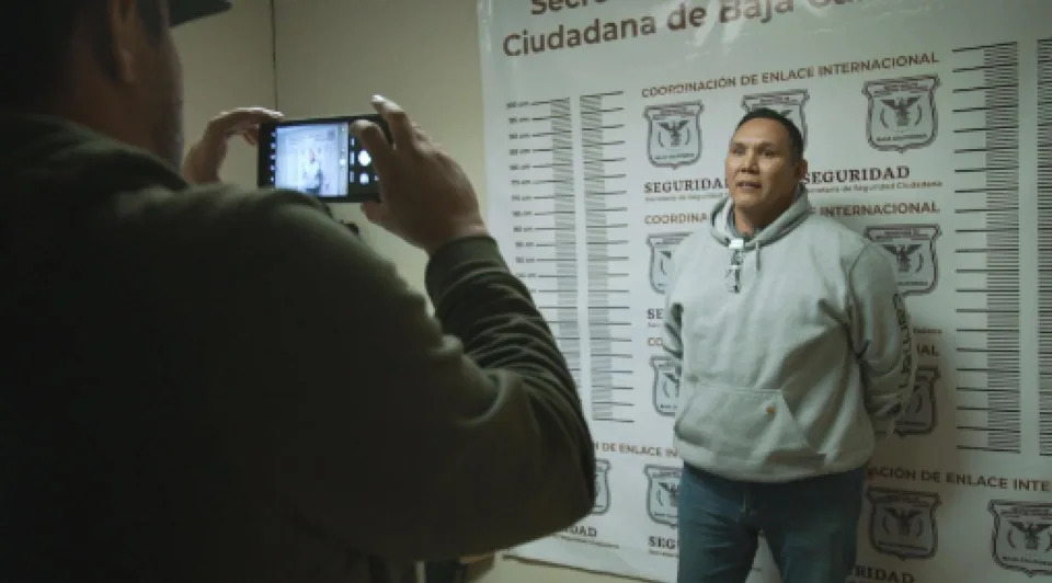 PHOTO: Terry Sakamoto, an American who was wanted in Mexico, is processed after his arrest. (ABC News)