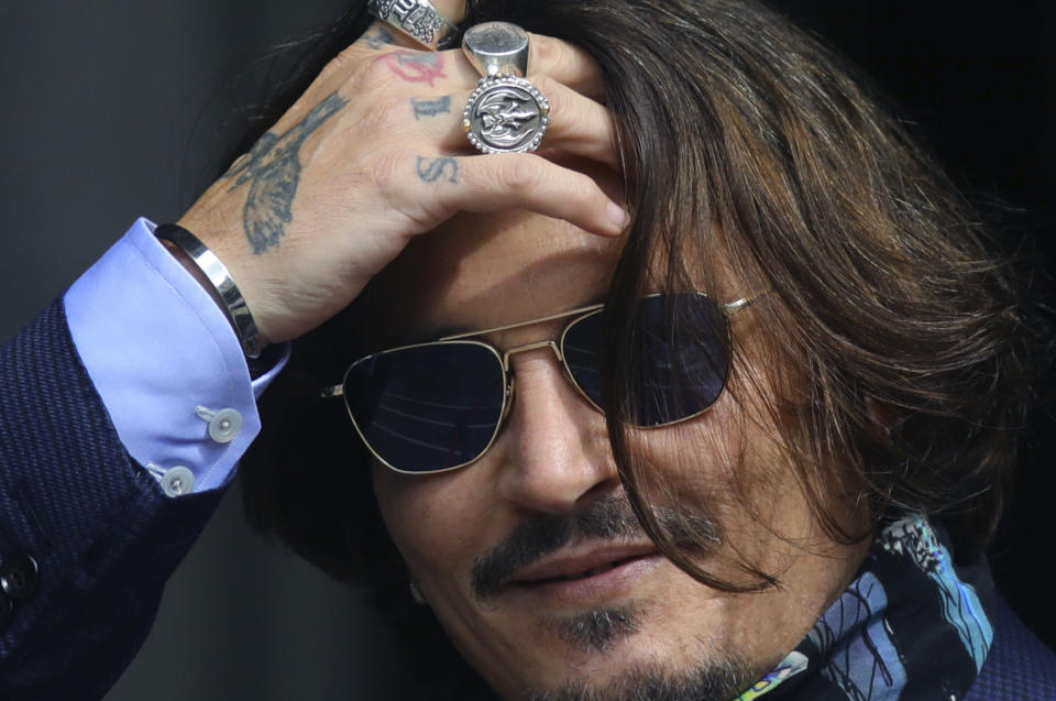 Actor Johnny Depp arrives at the High Court for a hearing in his libel case, in London, Friday, July 24, 2020. Depp is suing News Group Newspapers, publisher of The Sun, and the paper's executive editor, Dan Wootton, over an April 2018 article that called him a "wife-beater." The Sun's defense relies on a total of 14 allegations by his ex-wife, actress Amber Heard of Depp's violence. He strongly denies all of them. (Aaron Chown/PA via AP)