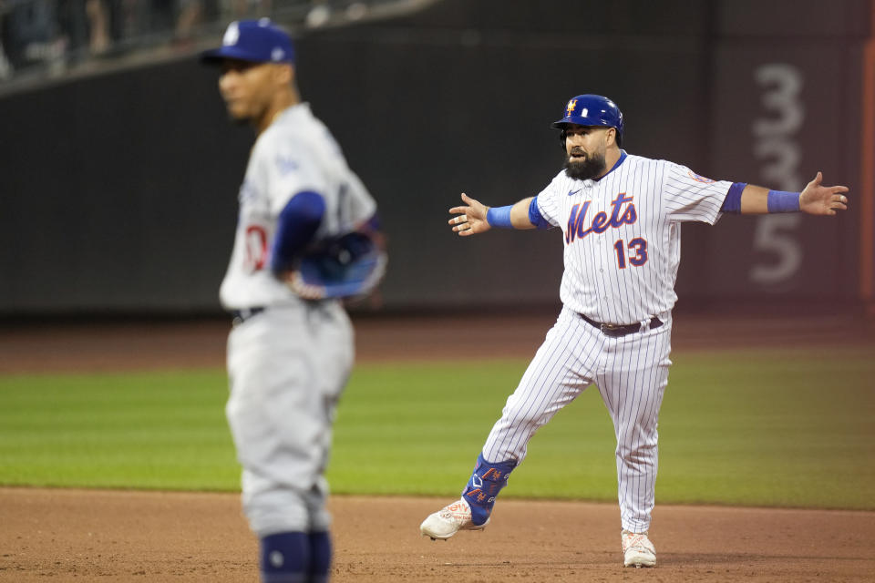 New York Mets' Luis Guillorme, right, reacts after hitting a walk-off RBI single during the tenth inning of the baseball game against the Los Angeles Dodgers at Citi Field, Sunday, July 16, 2023, in New York. The Mets defeated the Dodgers in extra innings 2-1. (AP Photo/Seth Wenig)