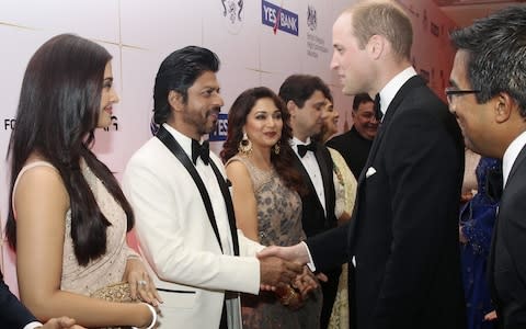 Britain's Prince William shakes hands with Bollywood actor Shah Rukh Khan - Credit: REUTERS/Rafiq Maqbool/Pool