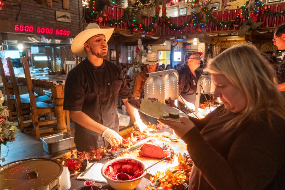 A guest looks over the buffet in November at the annual holiday meal at the Big Texan in Amarillo.