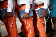 <p>Three boys hold rosaries and books of the New Testament as they wait for the start of a Corpus Christi procession in Port-au-Prince, Haiti May 26, 2016. (Andres Martinez CasaresREUTERS) </p>