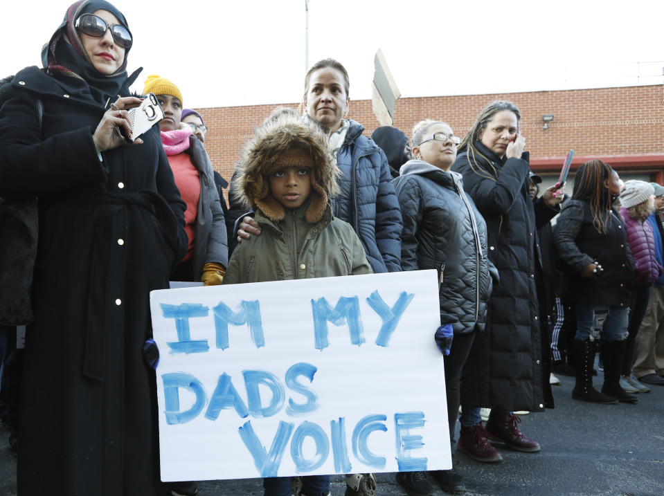 A youngster holds a sign as he joins protesters and other family members of inmates held a protest at the Metropolitan Detention Center, Sunday, Feb. 3, 2019, in New York. Prisoners have been without heat, hot water, electricity and sanitation due to an electrical failure since earlier in the week, including during the recent frigid cold snap. (AP Photo/Kathy Willens)